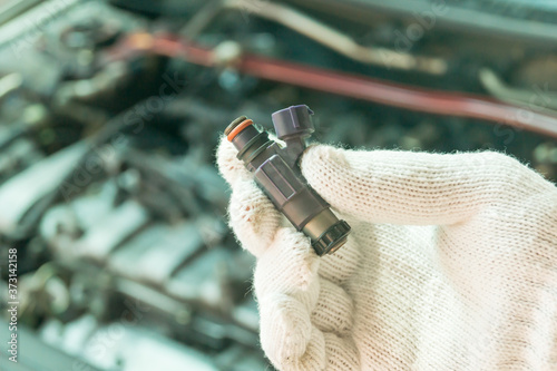 Close up of old fuel injector, Car maintenance service.