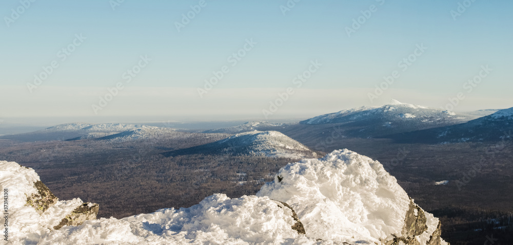 View of the Nurgush mountains made in the sunny winter morning View of the Nurgush mountains made in the sunny winter morning