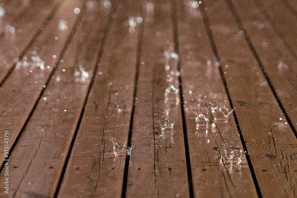 Rain from thunderstorm splash down on old worn wooden floor. Rain from thunderstorm splash down on old worn wooden floor.