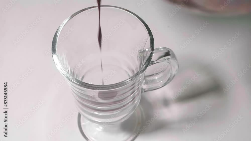 Hot chocolate is poured into clear glass. Dessert for those who has a sweet tooth.