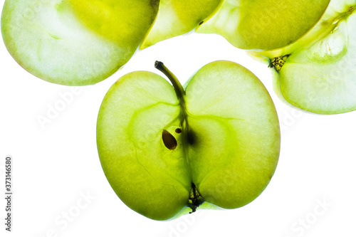 Slices of apple at the backlight isolated on a white background, macro photo