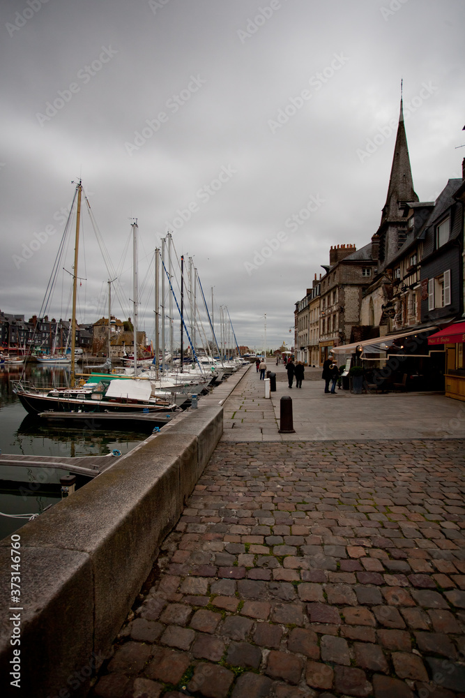 Yachts in the black port in Normandy before the rain