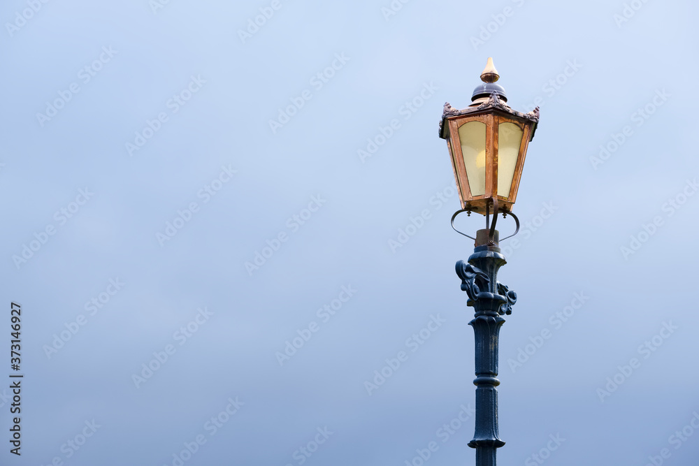 Back and copper victorian lamp post and dark sky