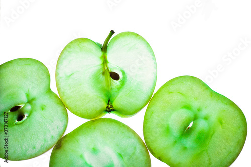 Slices of apple at the backlight isolated on a white background, macro photo