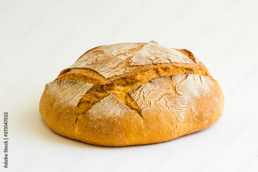 Rustic, whole-wheat round homemade whole bread on white with copy space