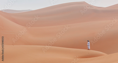 Emirati man walking in the empty quarter desert