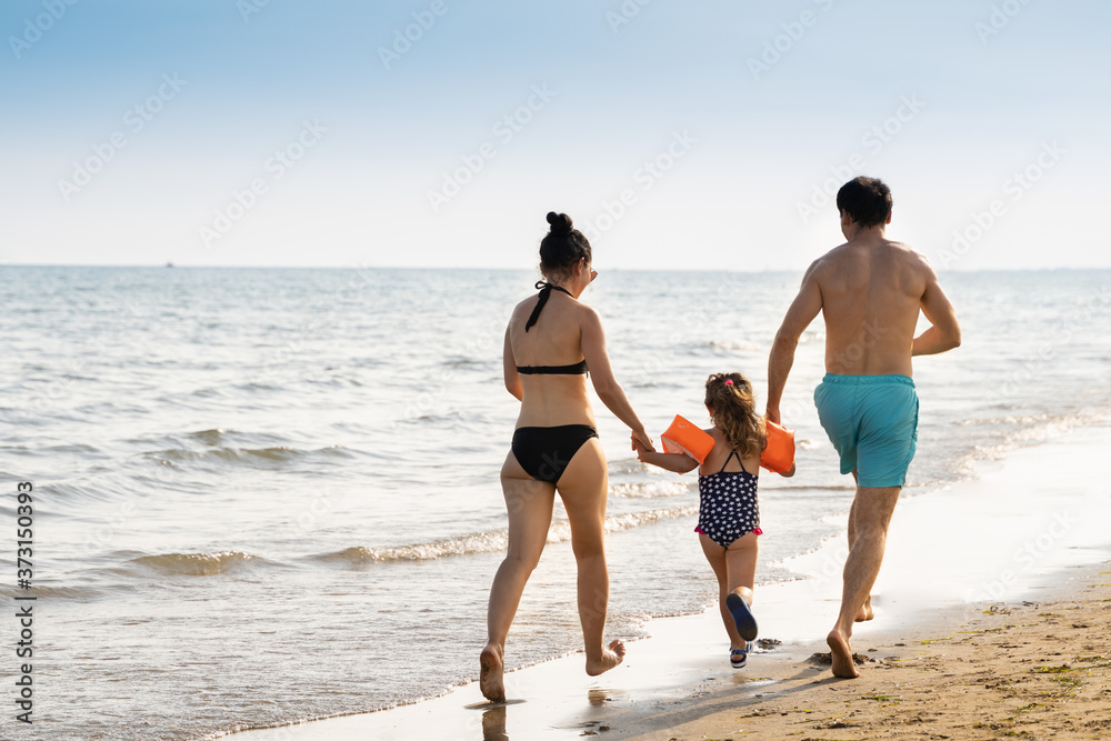 Family Running On Beach