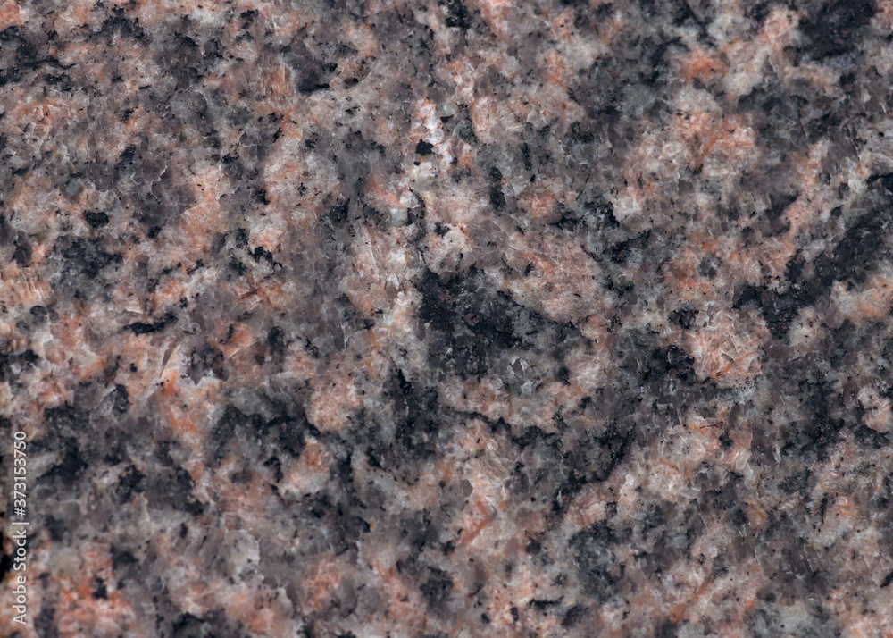 Texture of pink Baltic granite with quartz and mica feldspar granules Texture of pink Baltic granite with quartz and mica feldspar granules