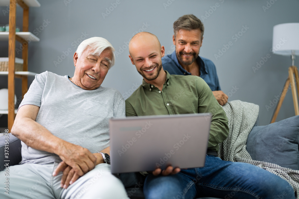 Happy Three Generation Men Using Laptop Happy Three Generation Men Using Laptop