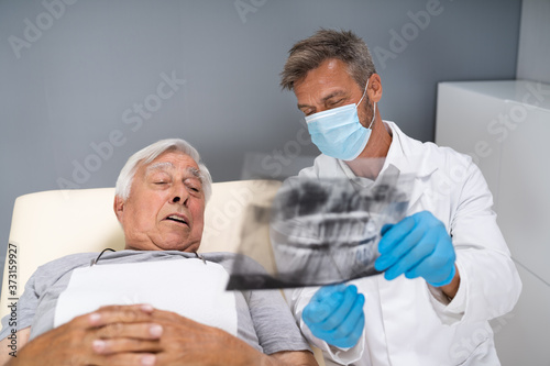 Dentist Examining Dental Xray