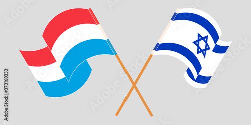Crossed and waving flags of Luxembourg and Israel