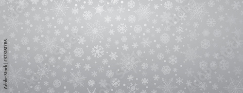 Christmas background of various complex big and small snowflakes, in gray colors
