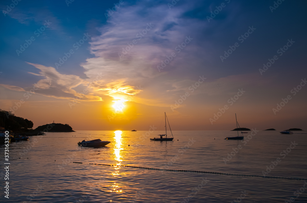 sunset on the adriatic sea - istria / croatia
orange sky and boat silhouettes against the setting sun