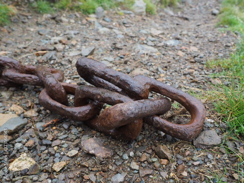 Close up of old rusty chain on the ground in the lake district