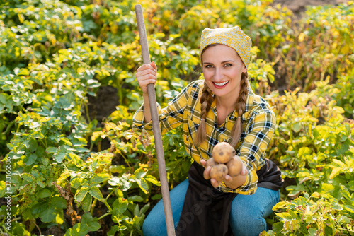 Famer woman presenting her potatoes during harvest