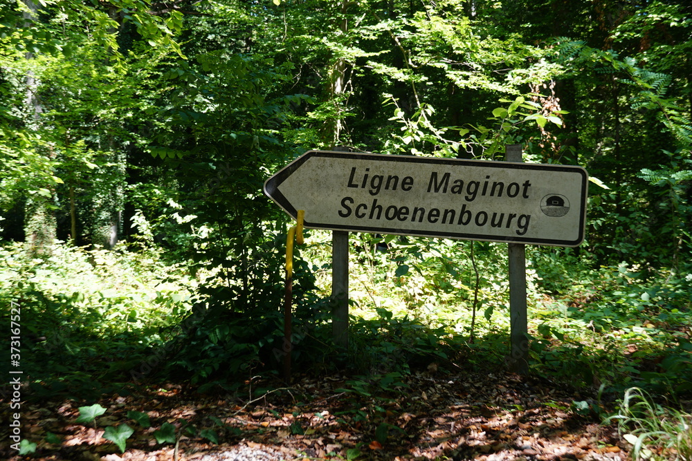 A direction shield pointing to Maginot line and its fortification Schoenenbourg in Eastern France on the Border with Germany. The shield is directing the visitors and tourists who come for sightseeing