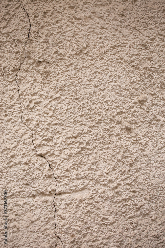 beige textured wall made of cement and sand. natural background for design beige textured wall made of cement and sand. natural background for design