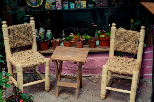 Couple of chairs made of wood and abaca rope with a wooden table in the middle photo