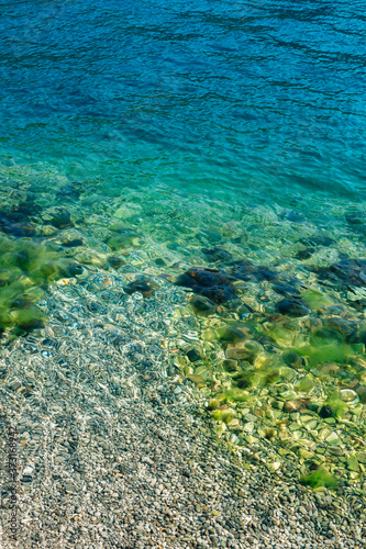 Fototapeta Naklejka Na Ścianę i Meble -  Blue sea water with stones in moss.