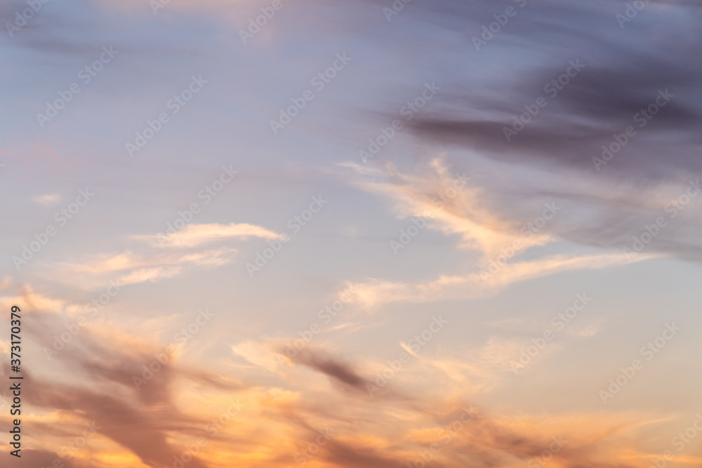 Obraz premium Beautiful bright sunset. Soft colors of clouds and sky. Quiet background. Orange and blue colors. Horizontal photo