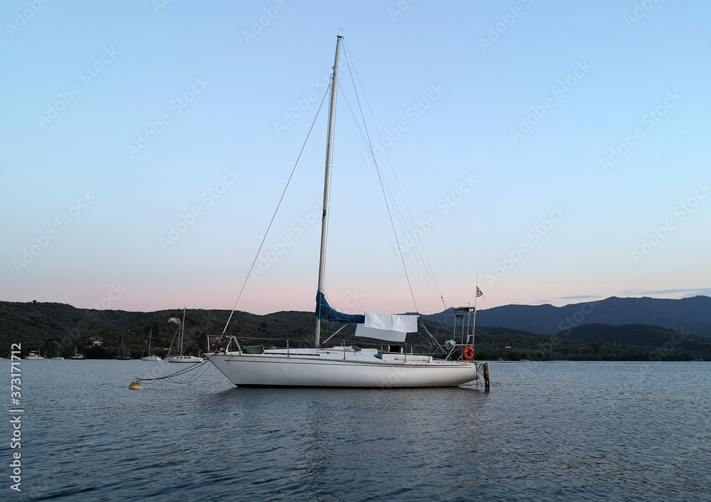 A sailboat anchored in a bay
