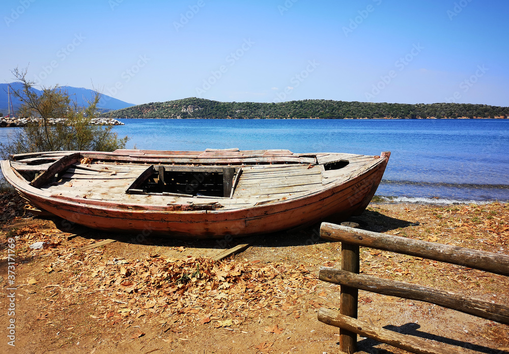 Abandoned old rusty wooden boat on the shore