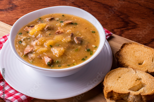 .Cassava broth. Creamy broth made with cassava, sausage, bacon and meat. .Accompanied by toast Top view Top view photo