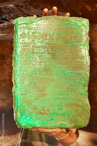 Detail of mysterious artifact emerald tablet found by adventurer in cave  foto de Stock | Adobe Stock
