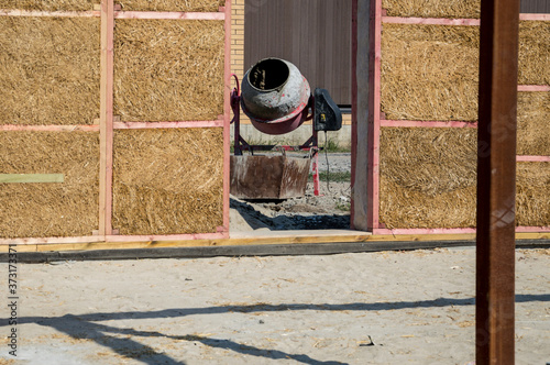 Construction of a house made of straw blocks.