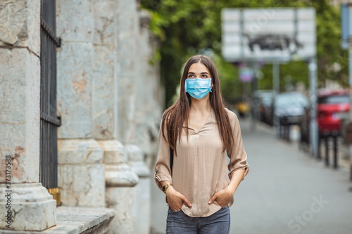 Student girl holding books while walking to school. She wears a mask for COVID-19, Corona virus protection. Back to school. Back to school with the face mask