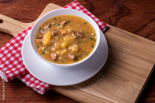 .Cassava broth. Creamy broth made with cassava, sausage, bacon and meat. Top view photo