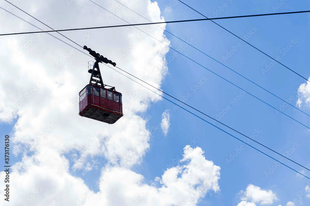 Cable car cabin on a sunny day against the blue sky
