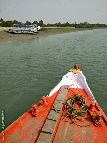 Prow of a bright red Fishing and tourist boat sailing in the Bay of Bengal- Sundarban, West Bengal, India- 9th Feb 2018