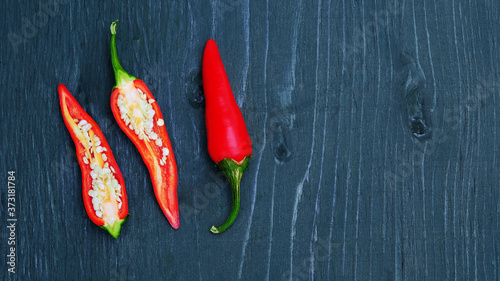 Red hot chili peppers on a wooden background, cut pepper.