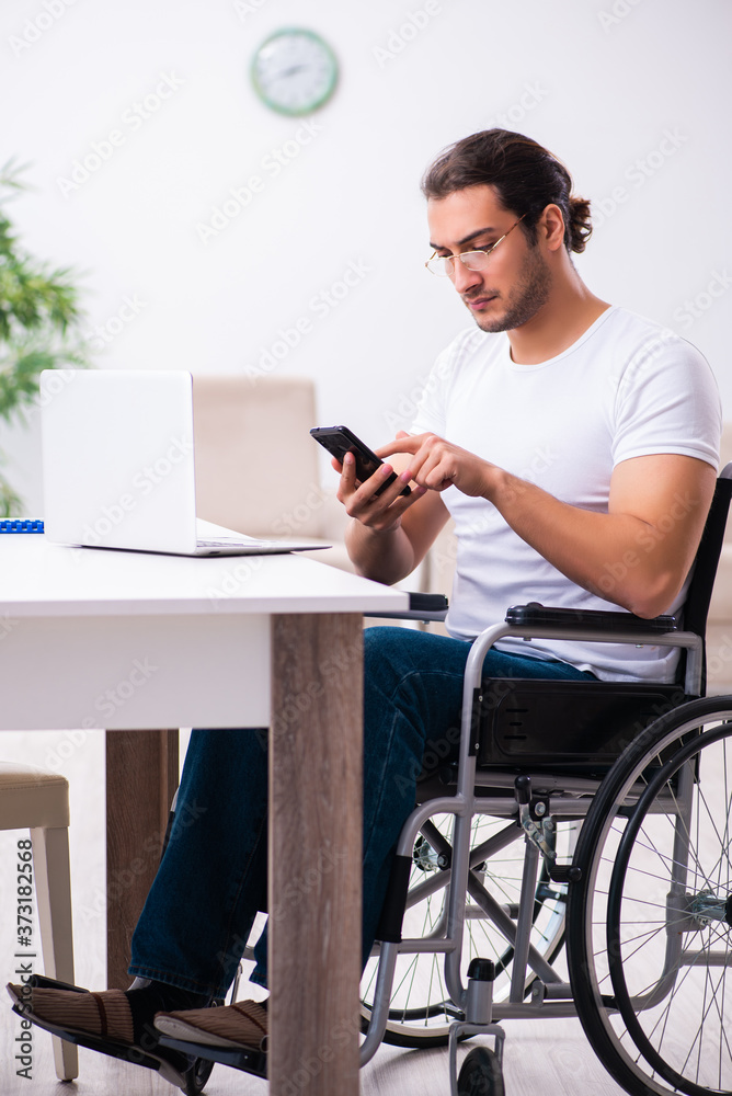Young disabled man working from house Young disabled man working from house