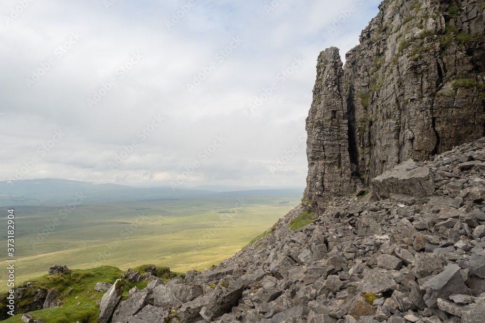 Pen-y-ghent Pinnacle. Pen-y-ghent or Penyghent is a fell in the Yorkshire Dales, England. It is the lowest of Yorkshire's Three Peaks at 2,277 feet; the other two being Ingleborough and Whernside