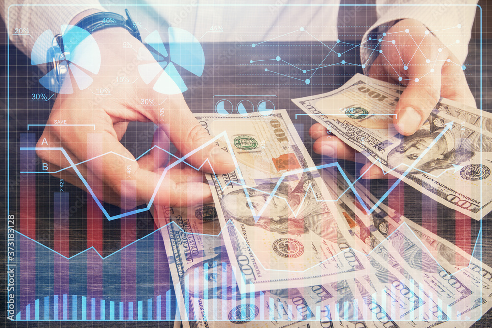 Multi exposure of financial graph drawing hologram and USA dollars bills and man hands. Analysis concept. Multi exposure of financial graph drawing hologram and USA dollars bills and man hands. Analysis concept.