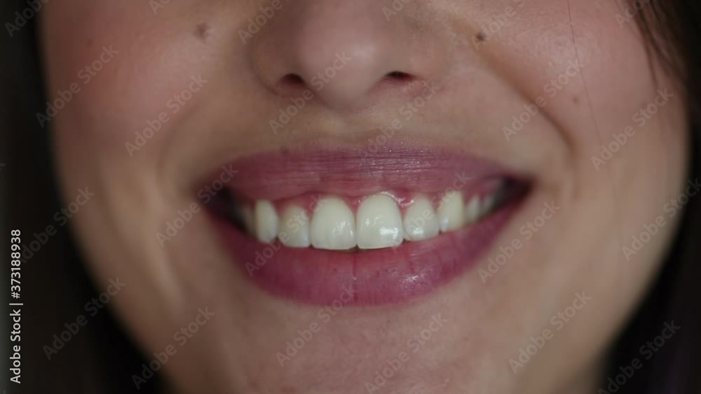Woman lips smiling at camera. Pretty girl smile white teeth close-up