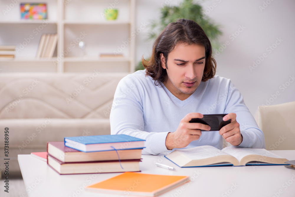 Young male student preparing for exams at home Young male student preparing for exams at home