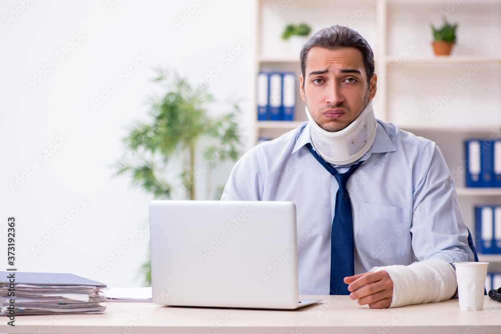 Injured male employee at workplace after accident
