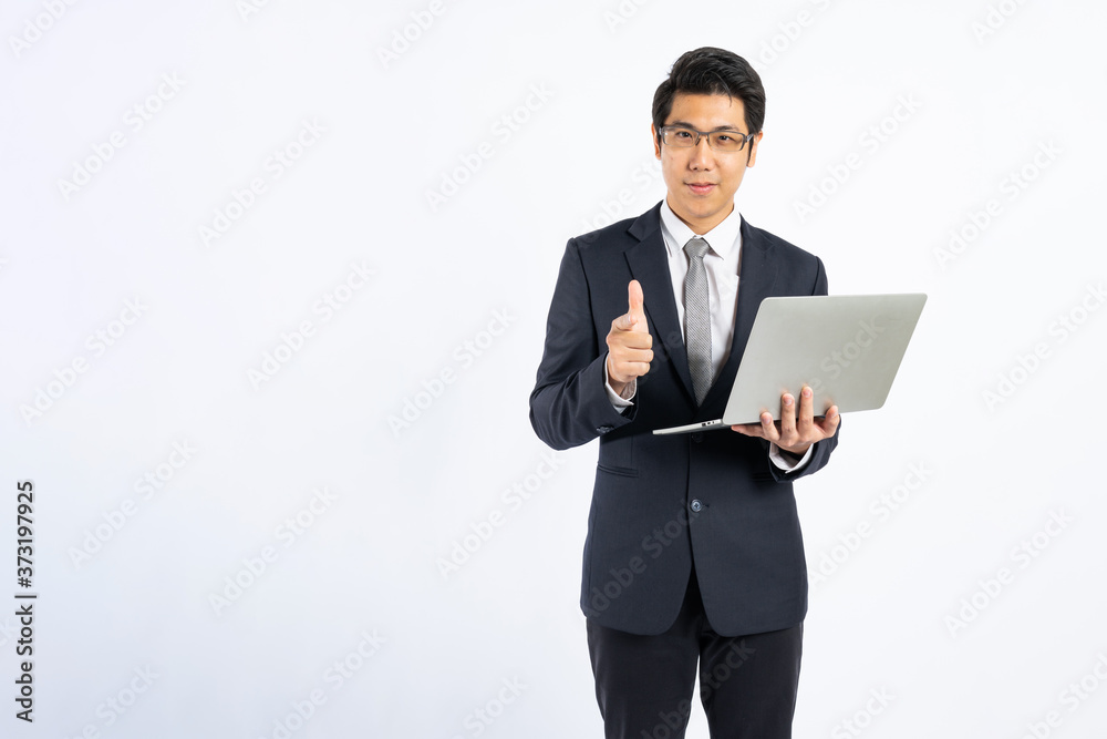 Smart Asian businessman holding laptop and show thumb up in studio on white background