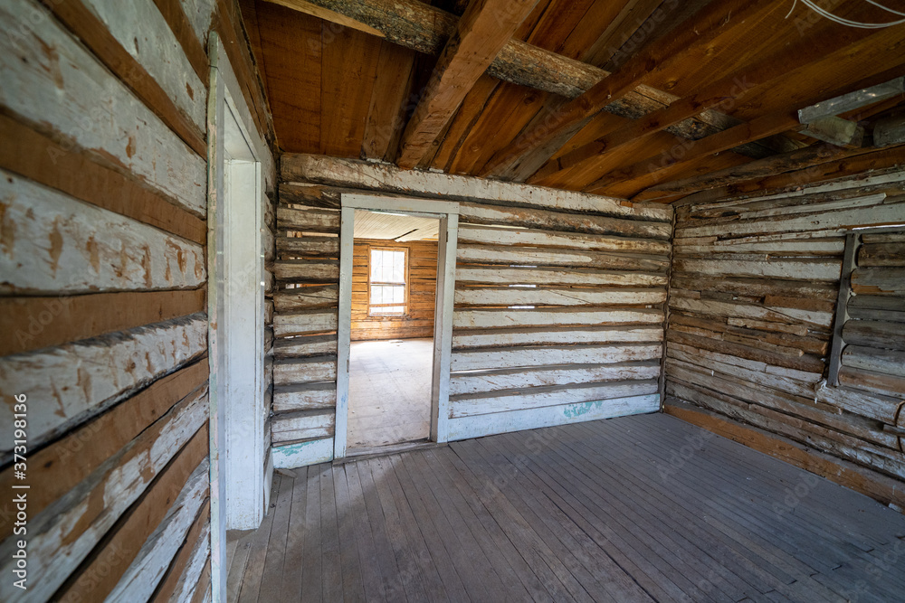 Creepy, vacant spooky interior of an abandoned log cabin in Bannack Ghost Town in Montana Creepy, vacant spooky interior of an abandoned log cabin in Bannack Ghost Town in Montana