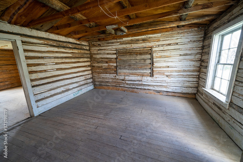 Creepy, vacant spooky interior of an abandoned log cabin in Bannack Ghost Town in Montana