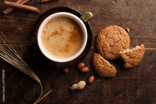 Cup of cofee and cereal cookies on the old wooden table. top view