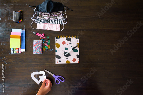 Back to School, stationery items display pencils, pen, scissiors, face mask, colour, pins