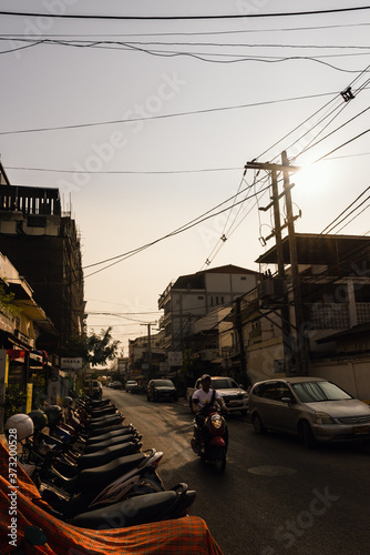 Bikes parked along a side street in late afternoon in Vientiane , Laos