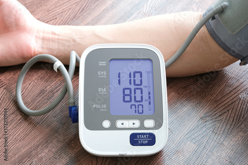 Man check blood pressure monitor and heart rate monitor with digital pressure gauge. Health care and Medical concept