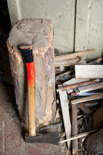 High angle vertical shot of an ax put by the stump