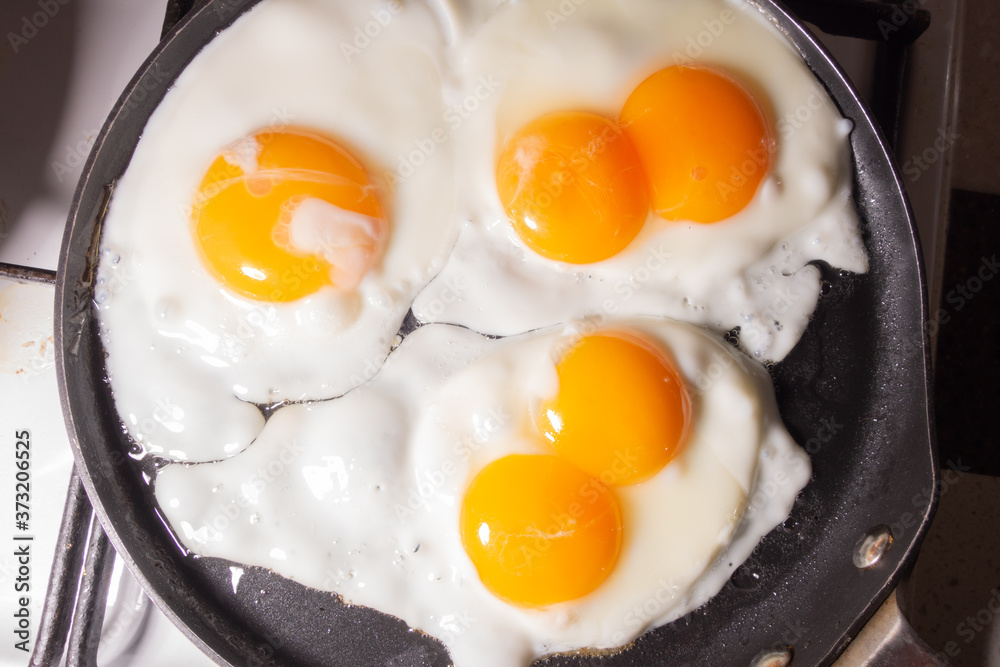 Fried eggs in a frying pan top view. An egg with two yolks. Fried eggs in a frying pan top view. An egg with two yolks.