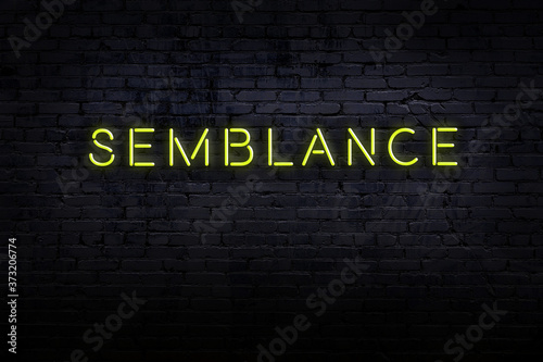 Night view of neon sign on brick wall with inscription semblance photo